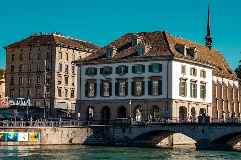 Scenic view of Zürich's historic waterfront and architectural charm on a sunny day.